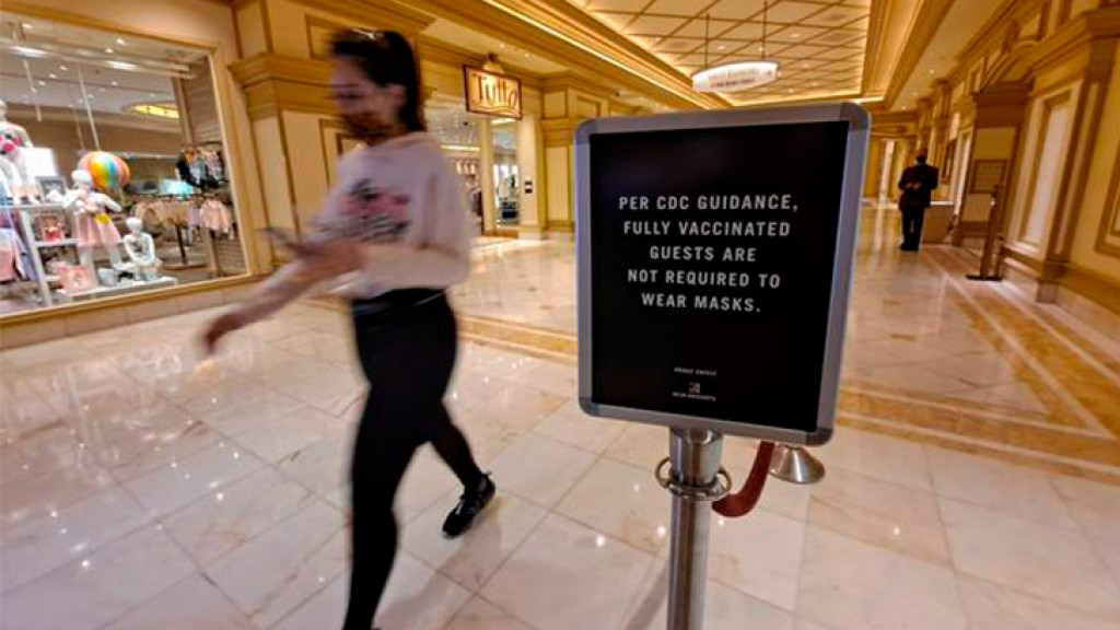 Some Las Vegas tourists eagerly shed masks as vaccinated return to normal life